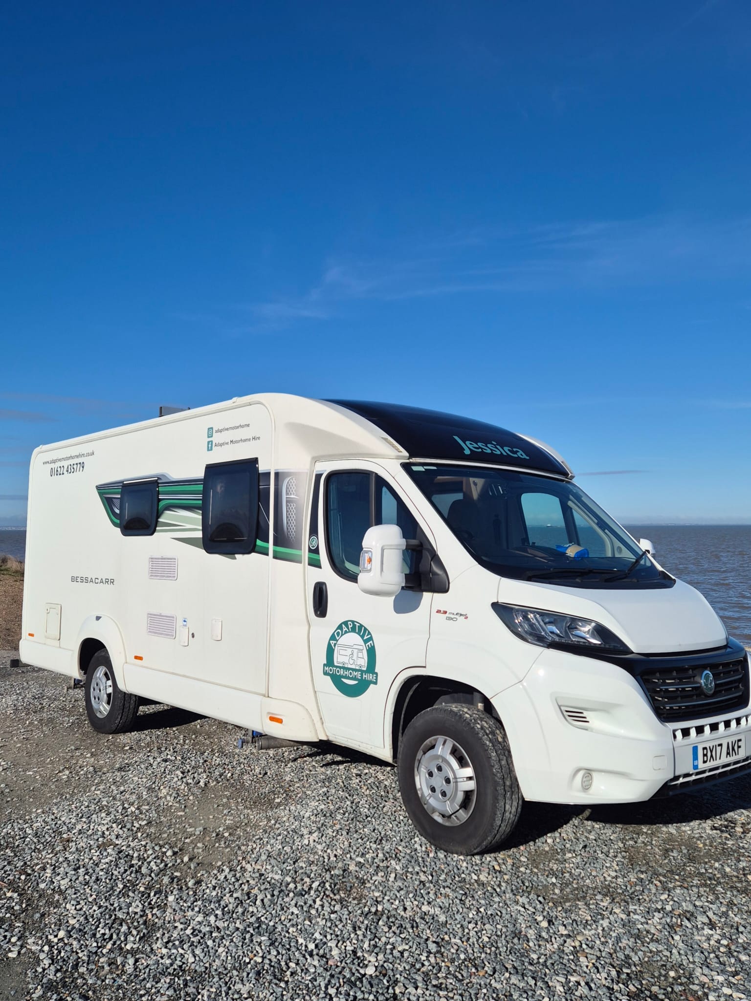 Jessica, the white adapted Bessacarr motorhome, parked beside the sea